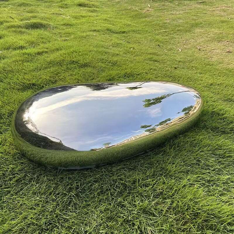 Mirror Polished Metal Garden Sculpture in the shape of a smooth pebble