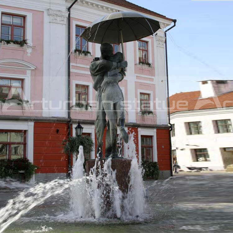 Boy and Girl Under Umbrella Fountain