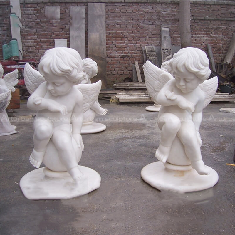 outdoor cherub statues with butterlfy