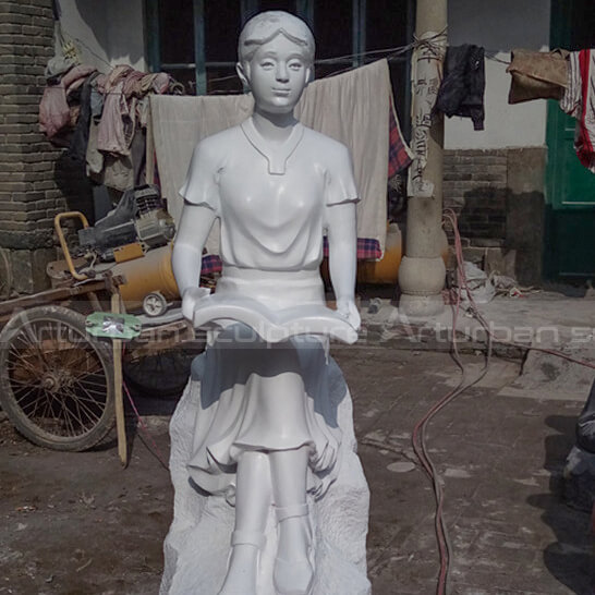 girl reading outdoor statue