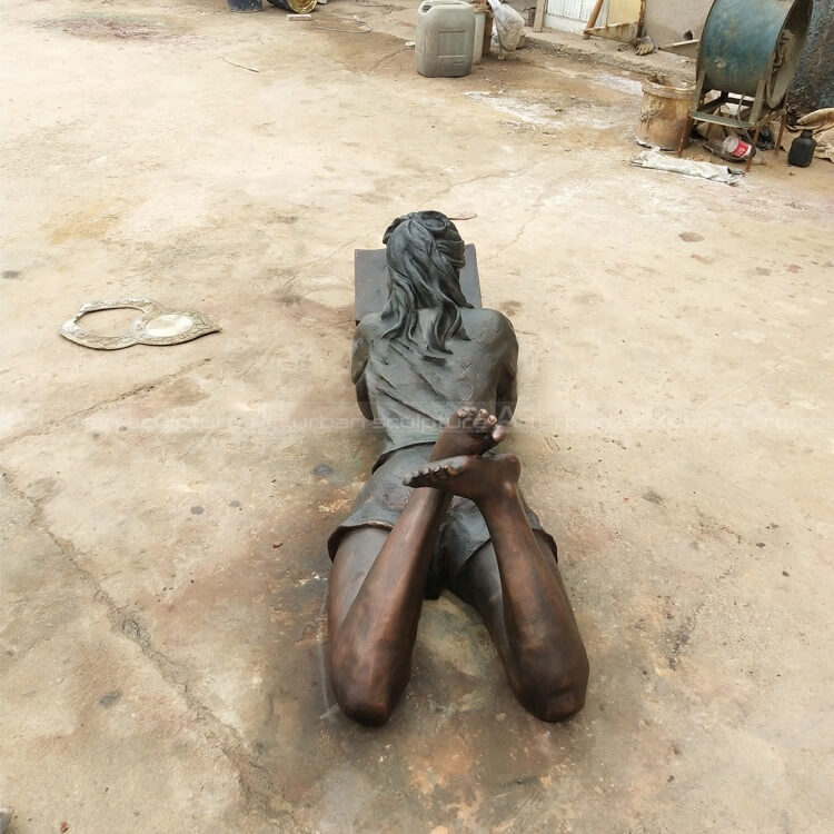 girl reading book statue