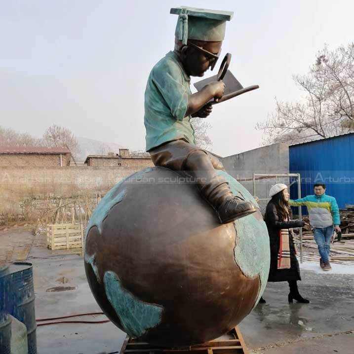 boy reading book statue