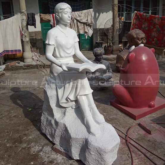 girl reading book statue