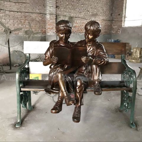 boy and girl reading together statue