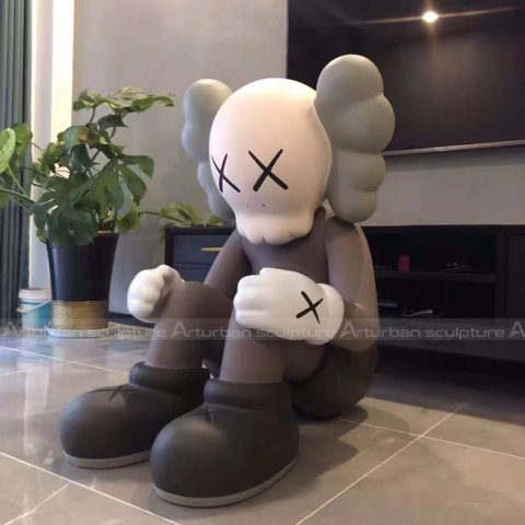 sitting kaws