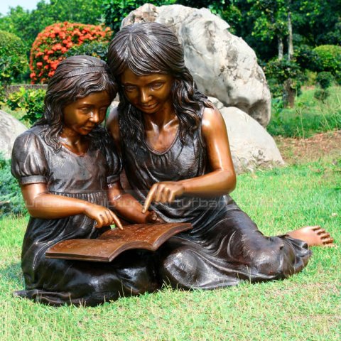 little girl reading book statue