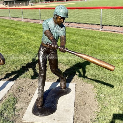 boy playing baseball statue