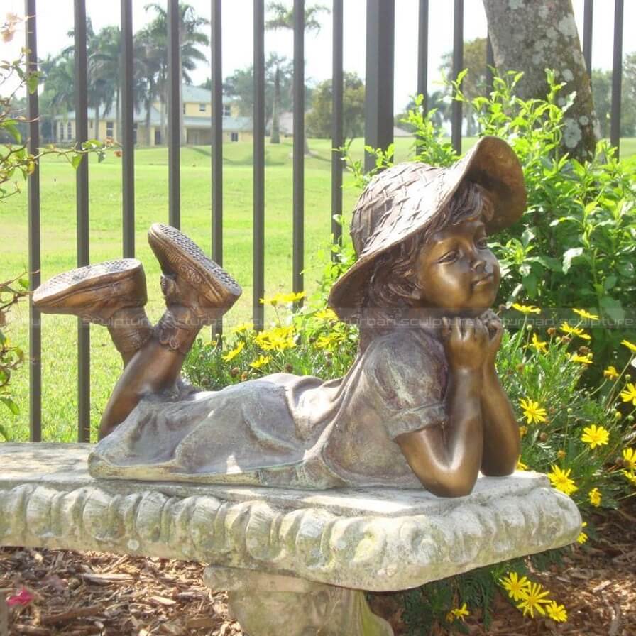 girl reading book sculpture