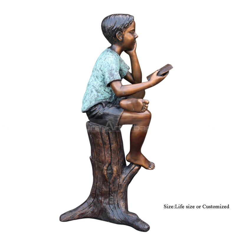 boy reading garden statue