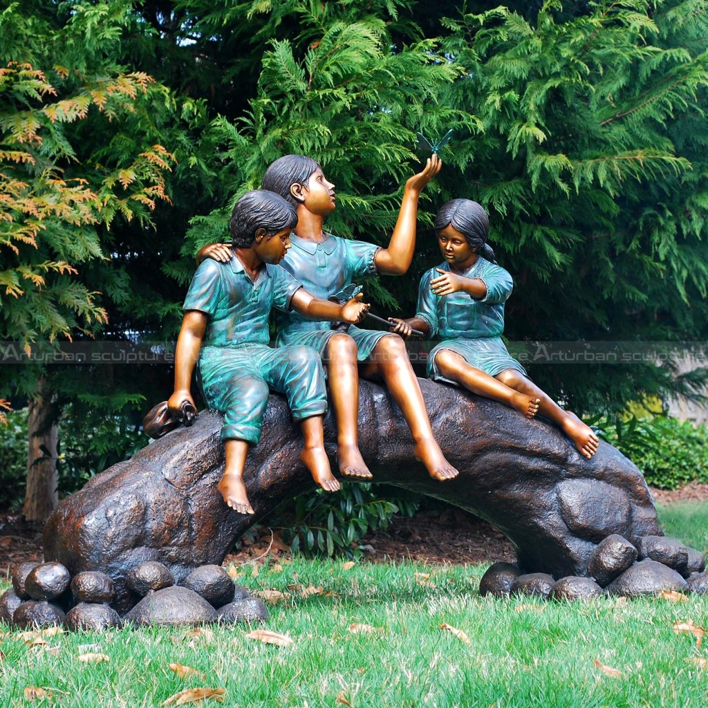 kid on tree trunk sculpture