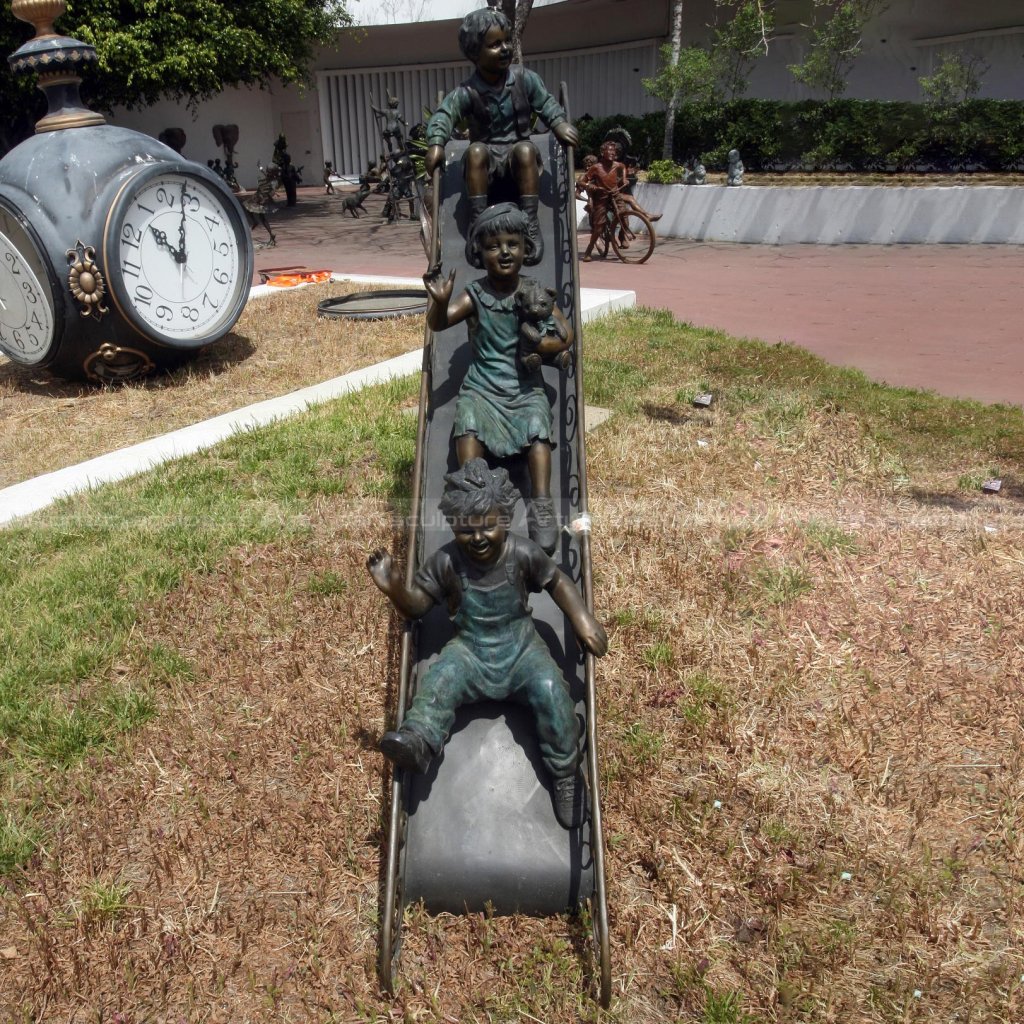 children on slide bronze statue