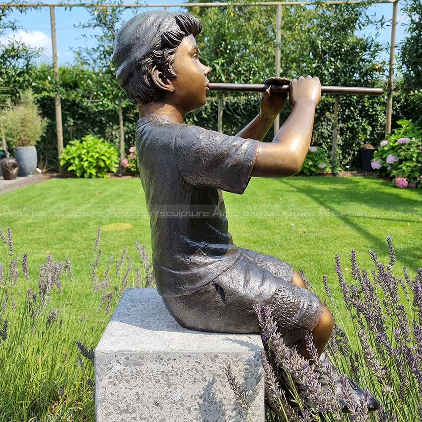 sculpture boy playing flute