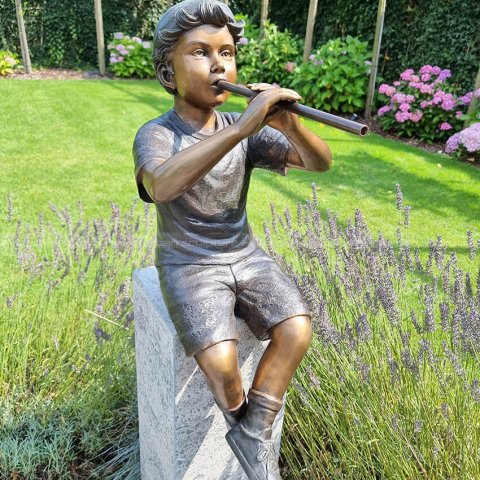 sculpture boy playing flute