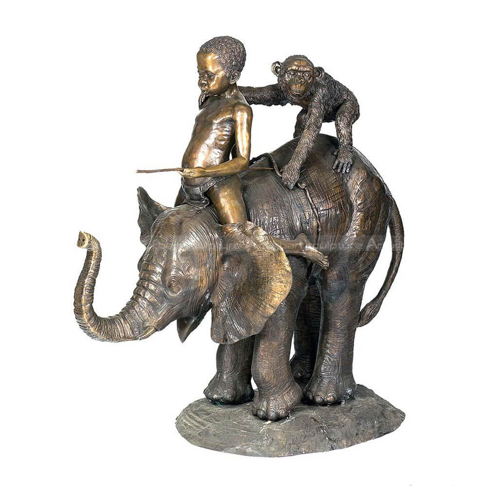 Boy sitting on elephant statue