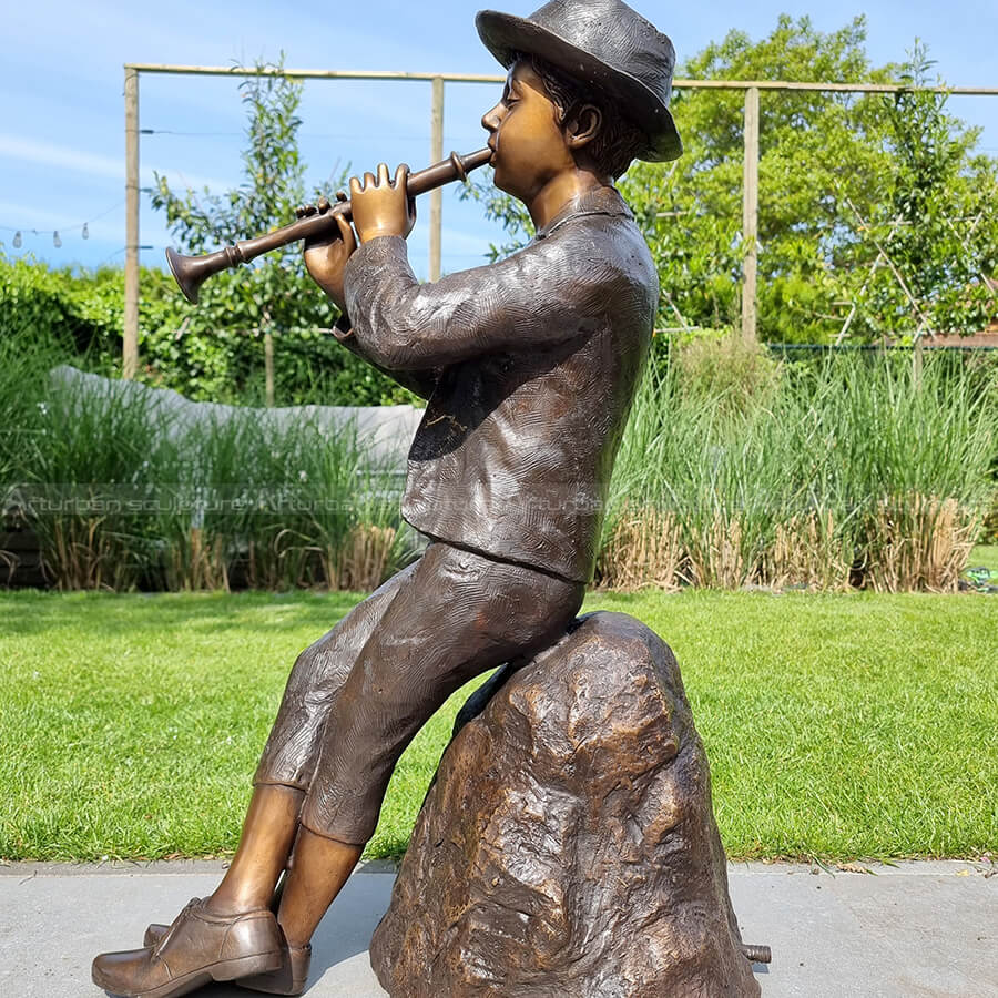 boy with flute statue