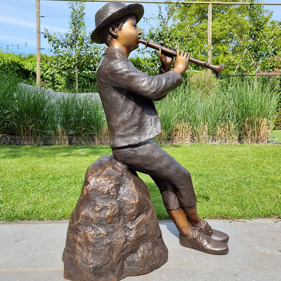 boy with flute statue