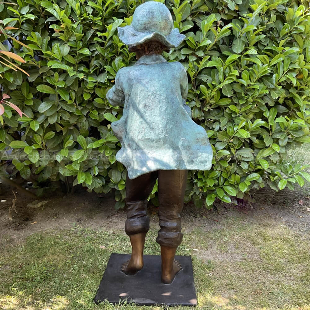 boy playing flute garden sculpture