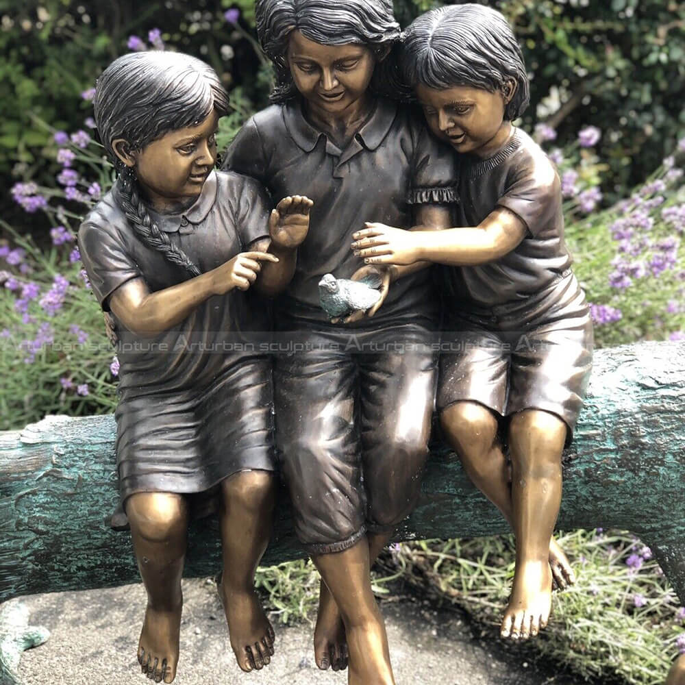 three kids on a log sculpture