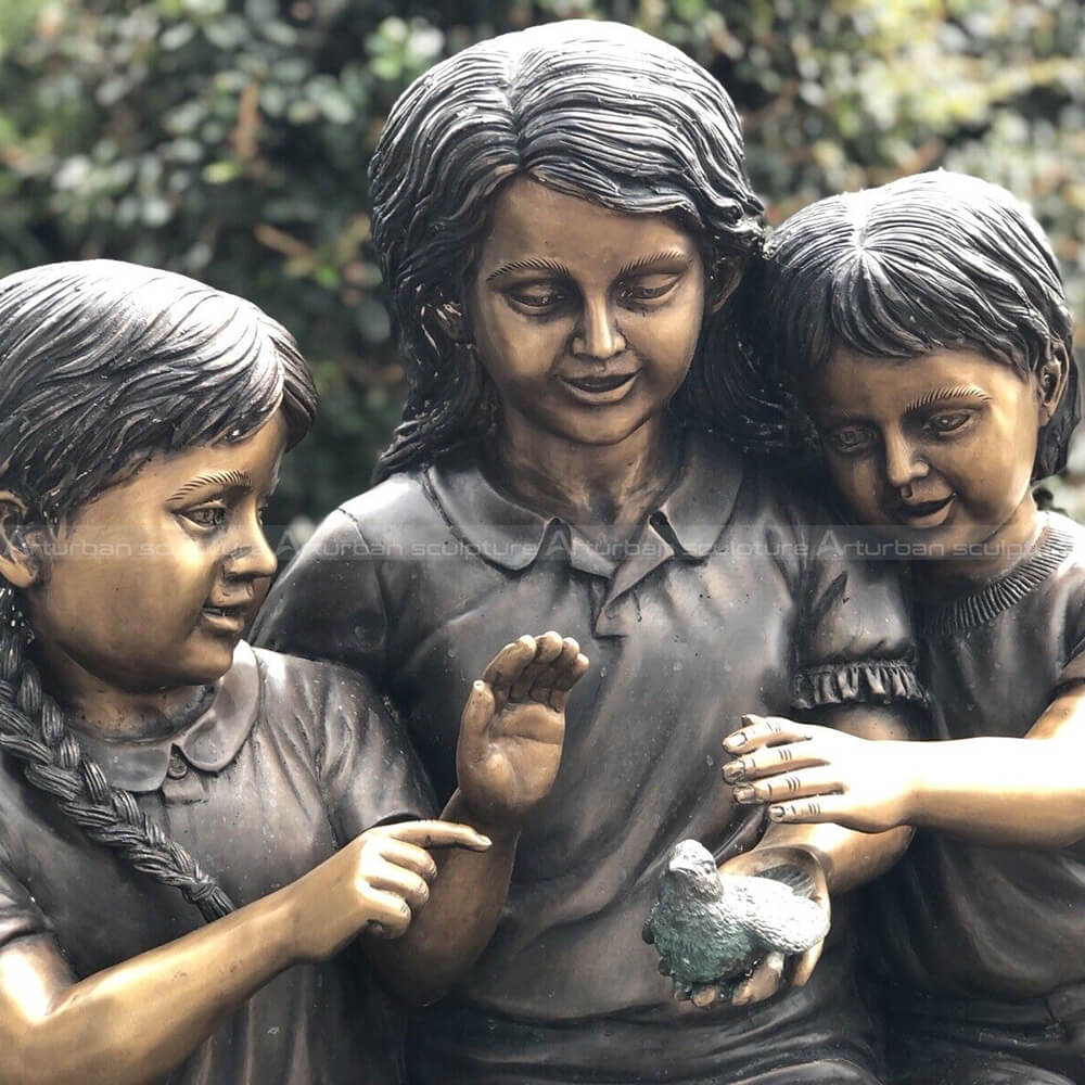 three kids on a log sculpture