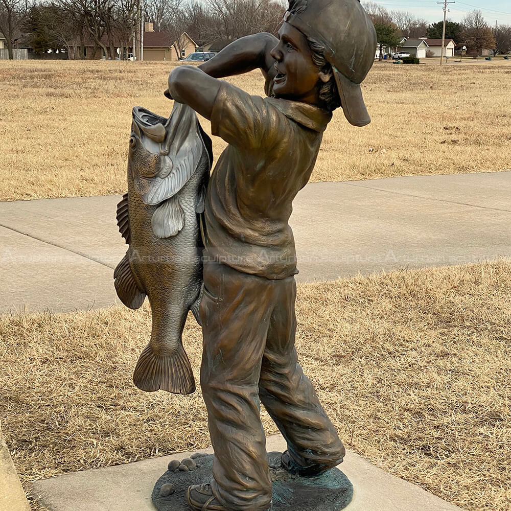 boy with big fish sculpture