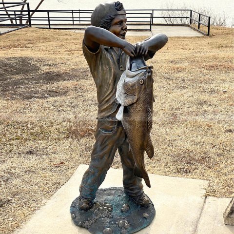 boy with big fish sculpture