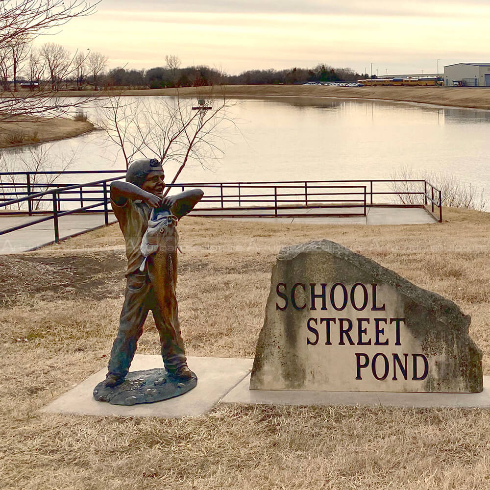 boy with big fish sculpture