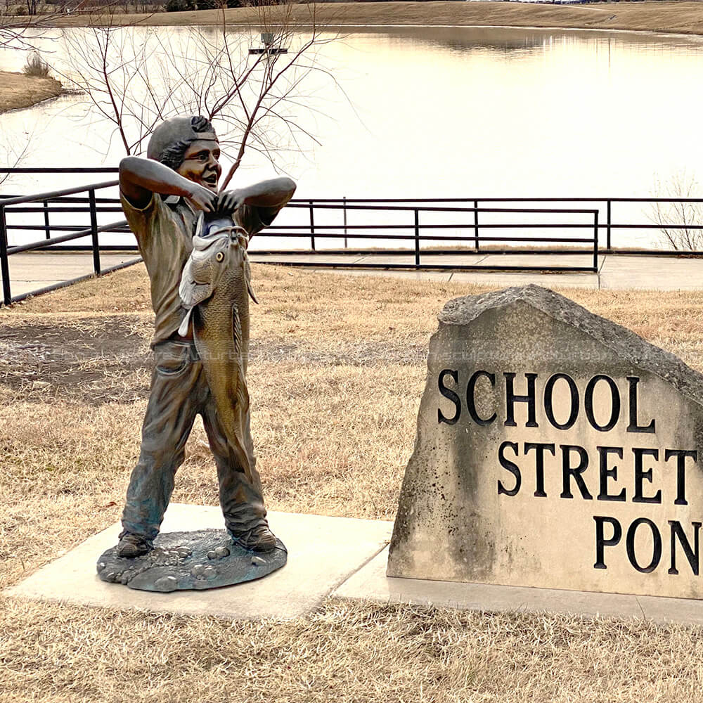 boy with big fish sculpture