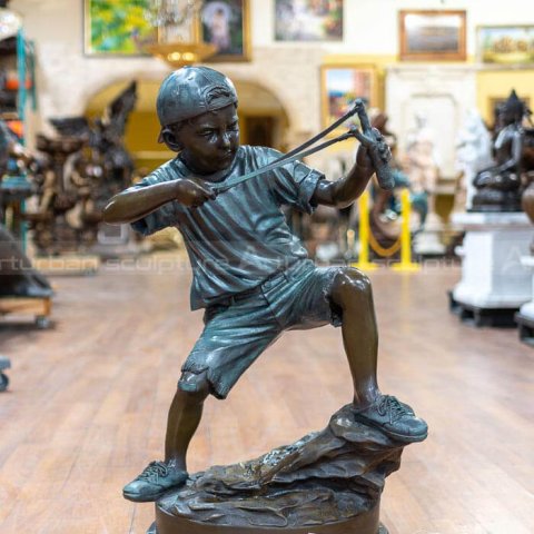 boy with slingshot sculpture