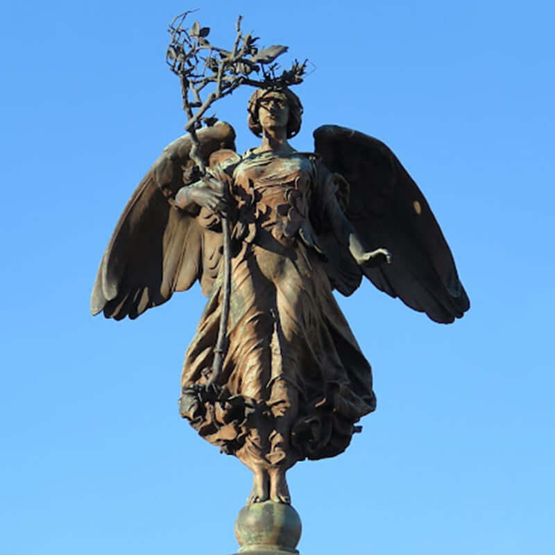 angel holding olive branch statue