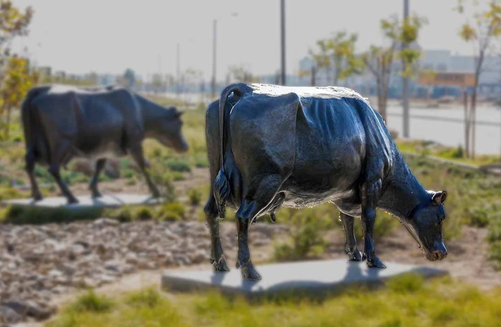 cow drinking statue