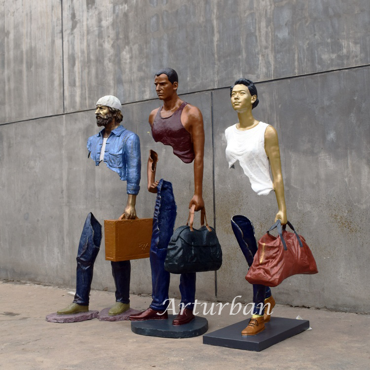 man with suitcase sculpture