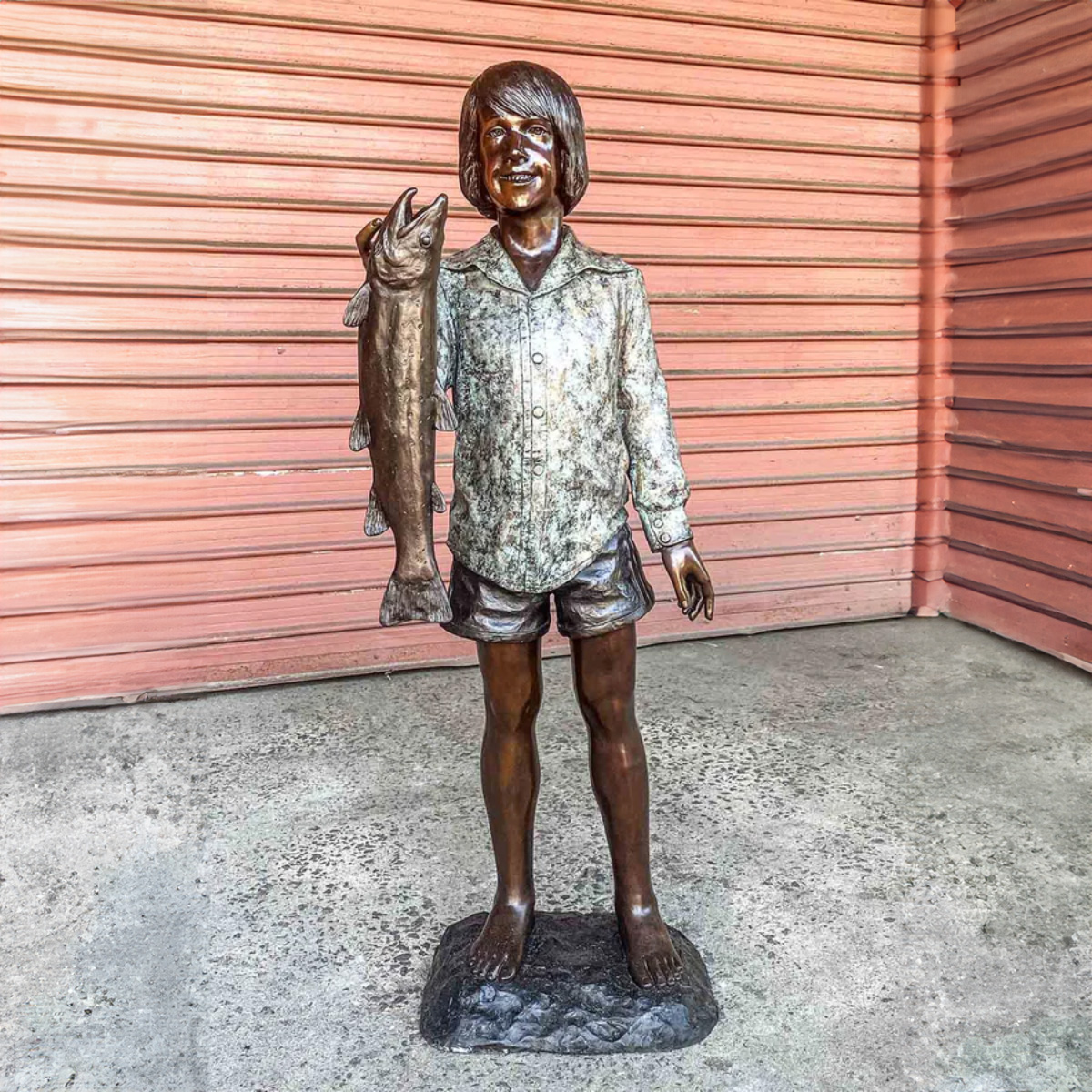 Boy Holding Fish Statue