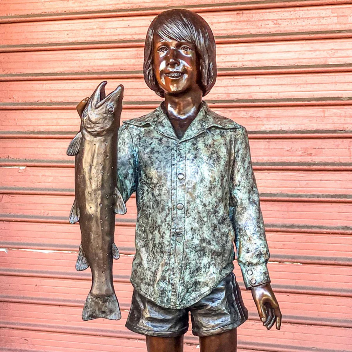 Boy Holding Fish Statue