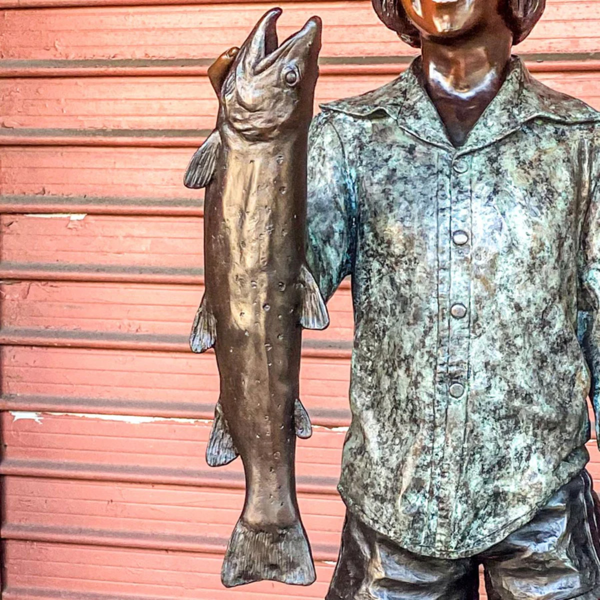 Boy Holding Fish Statue