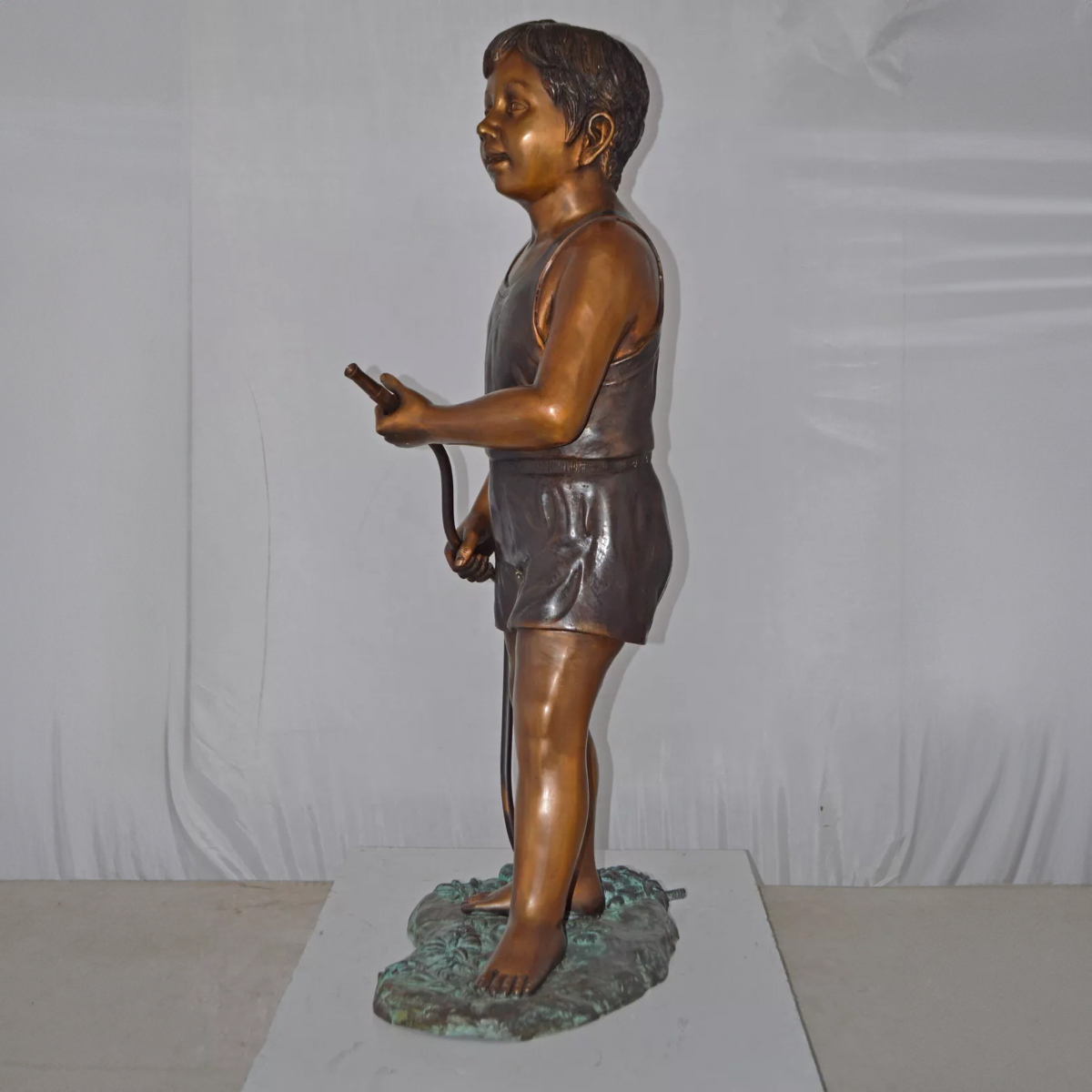 Boy Holding Garden Hose Sculpture