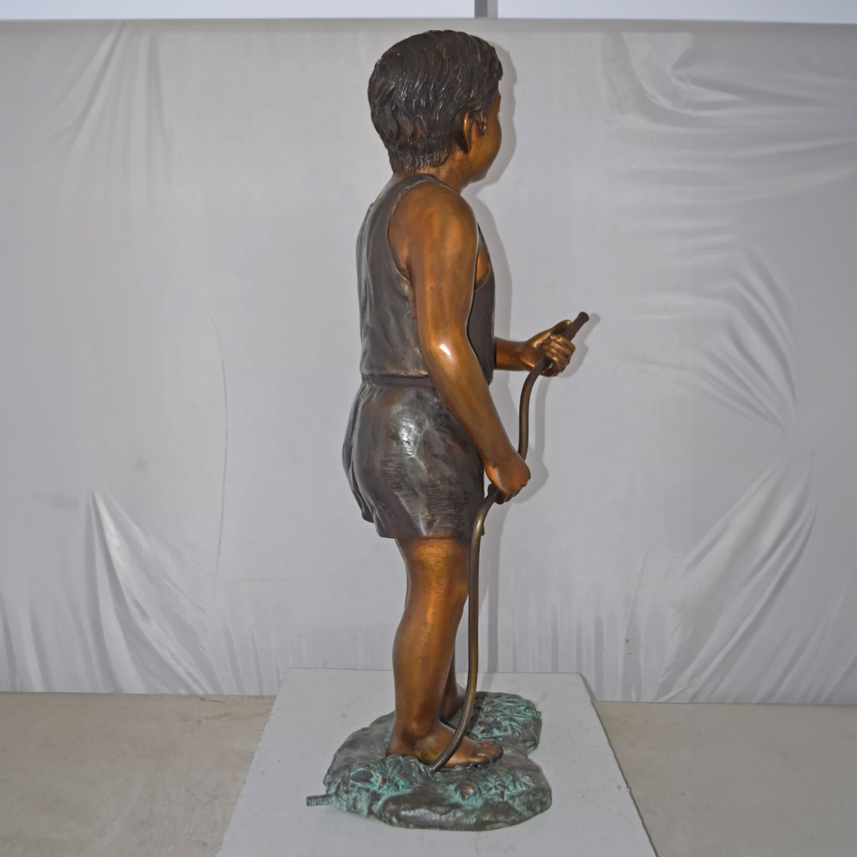 Boy Holding Garden Hose Sculpture