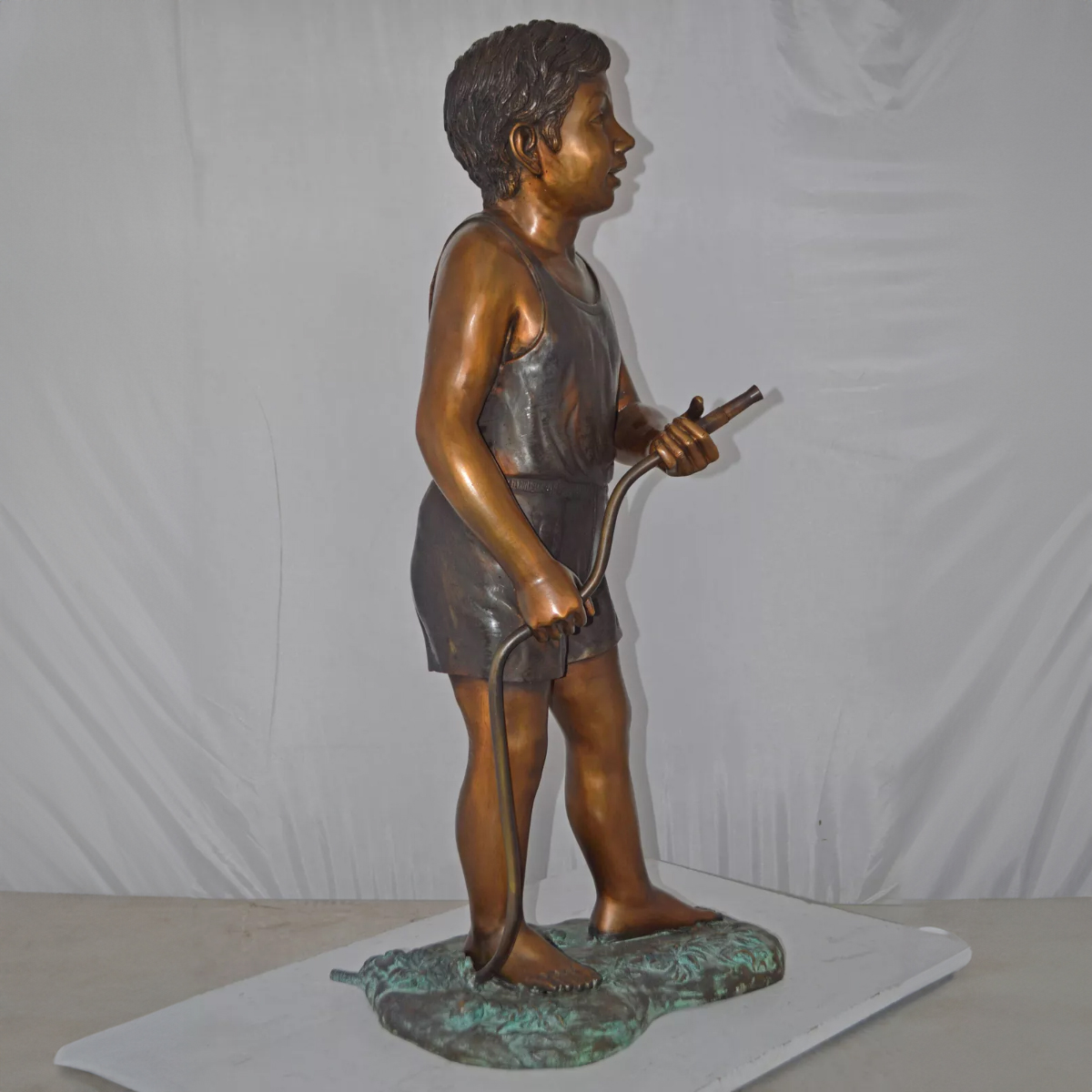 Boy Holding Garden Hose Sculpture