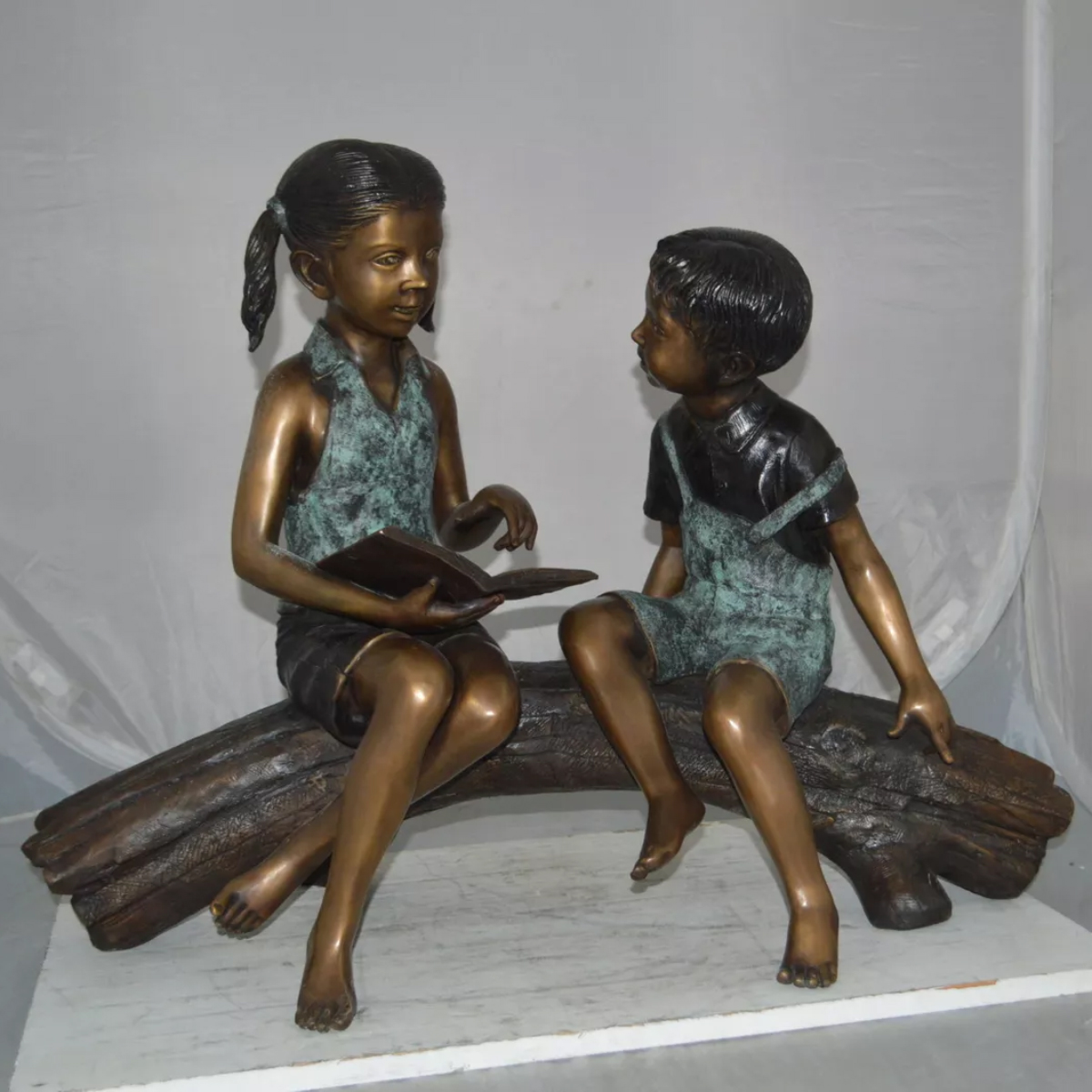 Boy and Girl Reading on a Log Statue