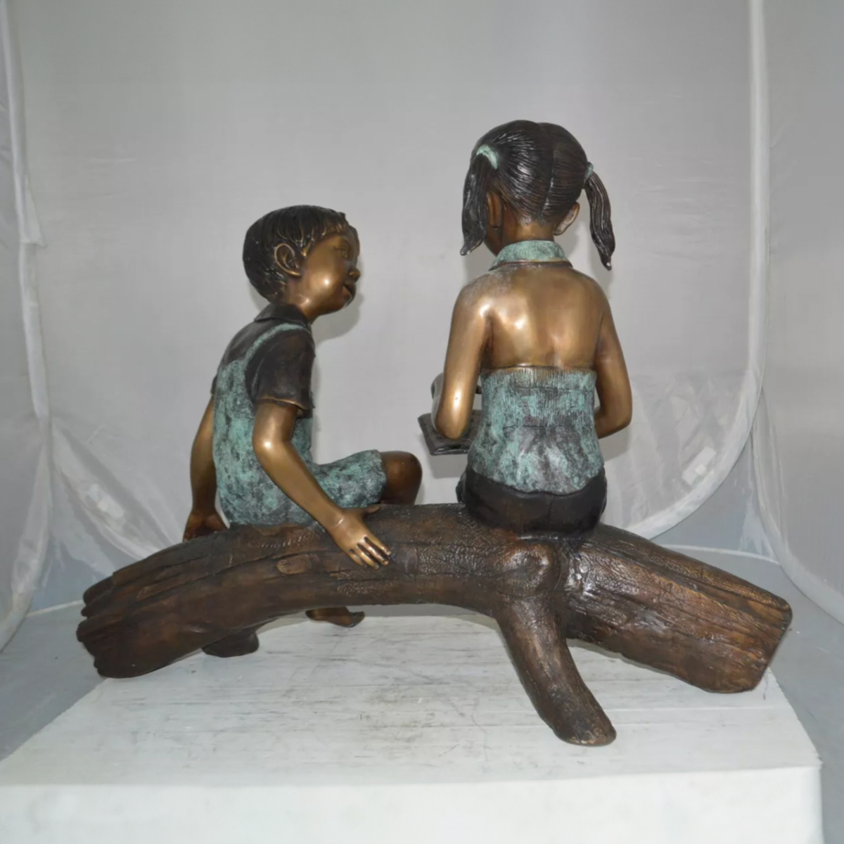 Boy and Girl Reading on a Log Statue