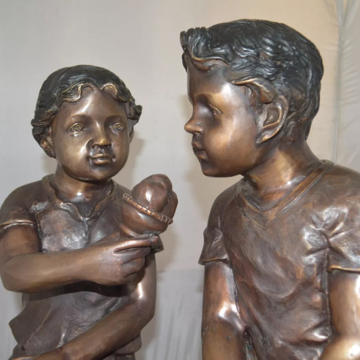 Boy and Girl Sitting Statue Outdoor