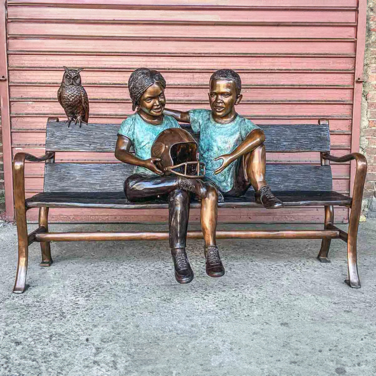 Boy and Girl Sitting on Bench Statue