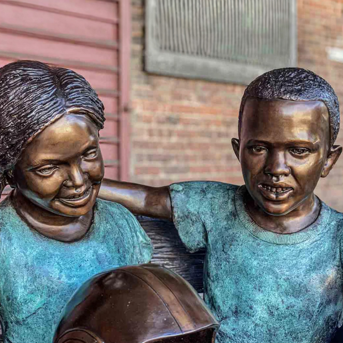 Boy and Girl Sitting on Bench Statue