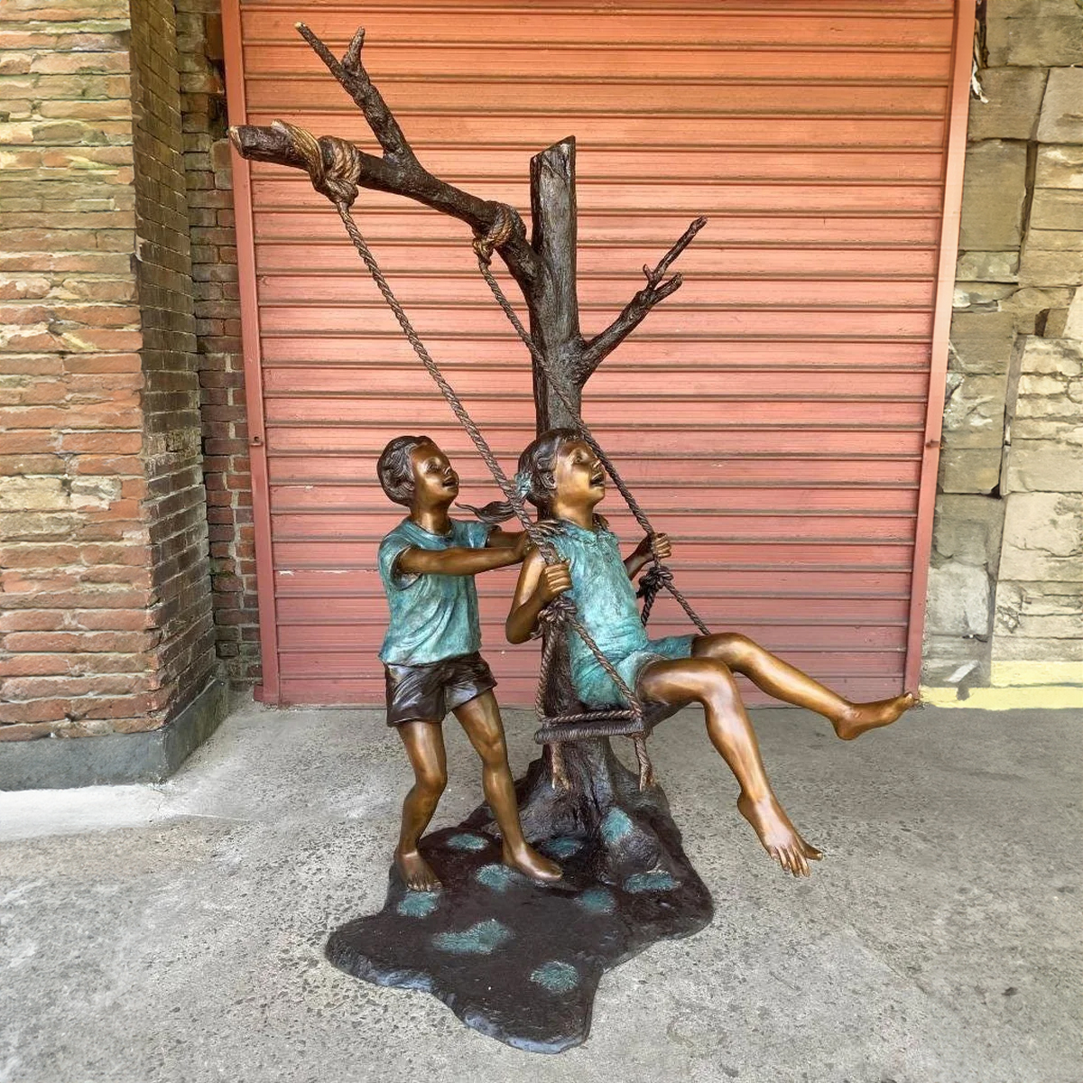 Boy and Girl Swinging Statue