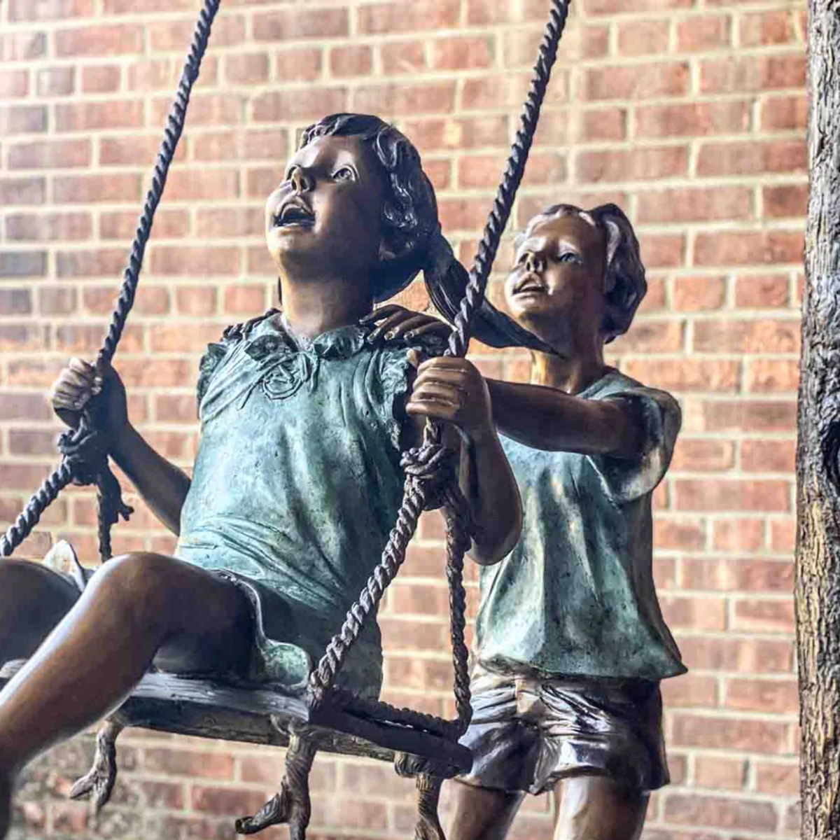 Boy and Girl Swinging Statue