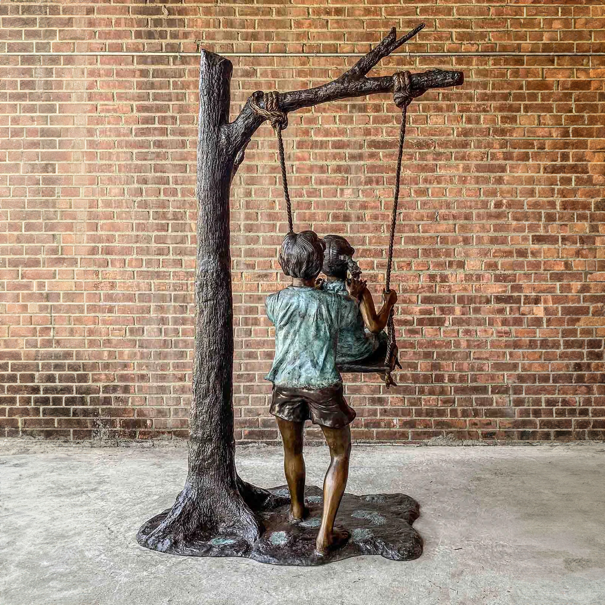 Boy and Girl Swinging Statue