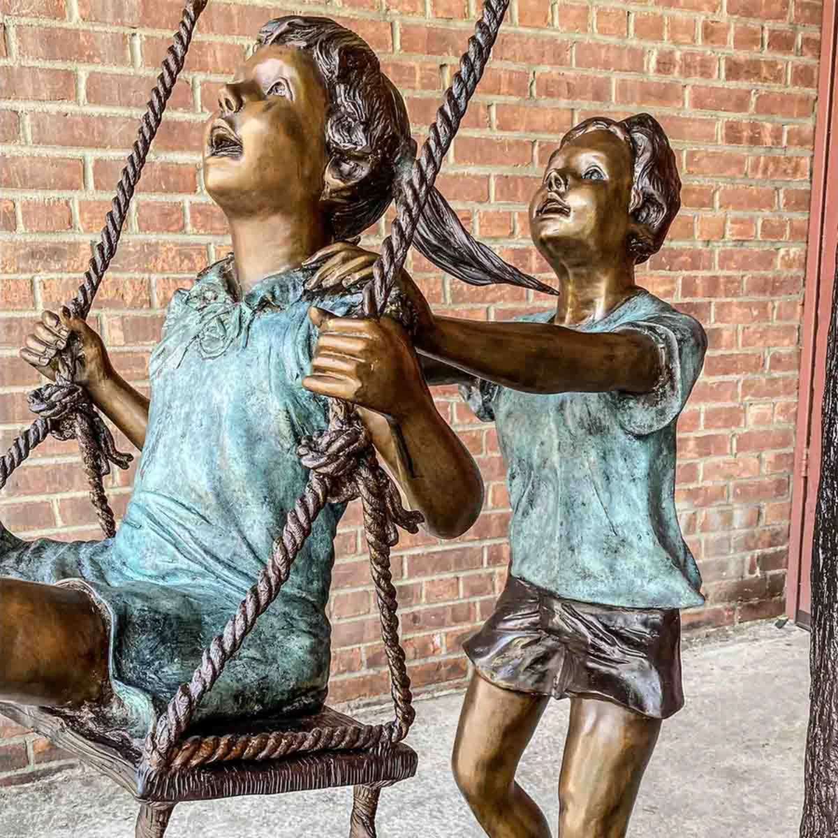 Boy and Girl Swinging Statue