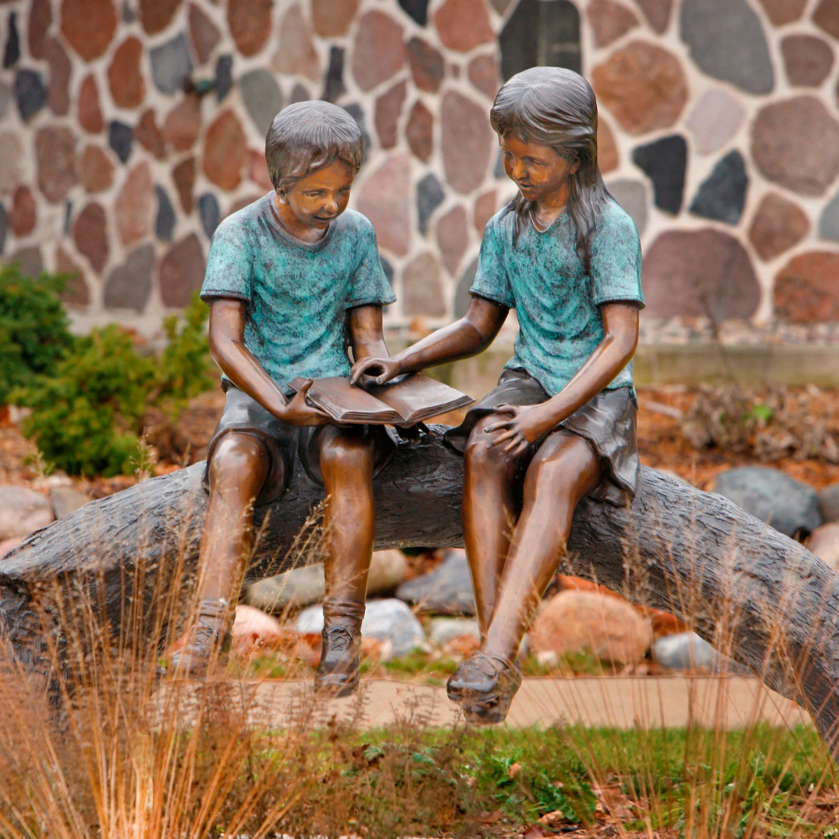 Boy and Girl on Log Reading Statue