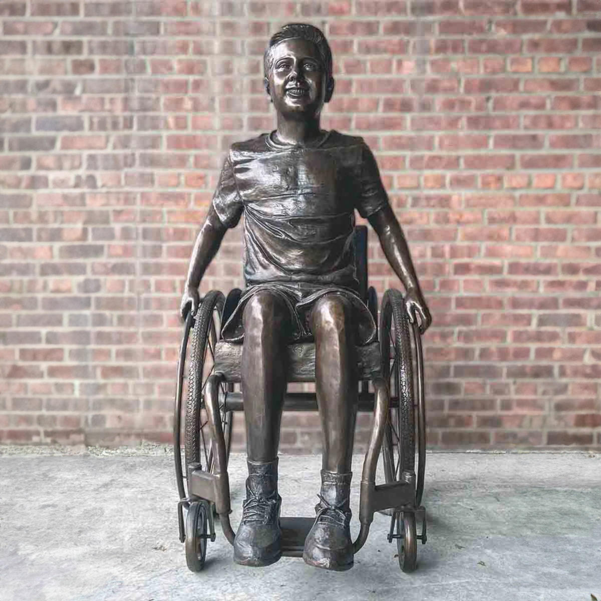 Boy in His Wheelchair Statue