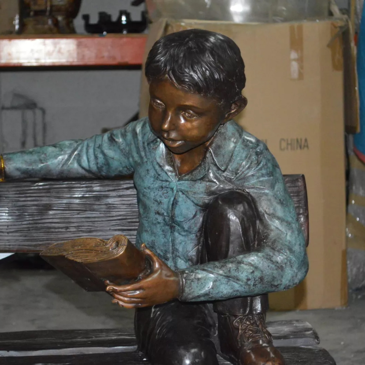 Boy on Bench Reading Sculpture