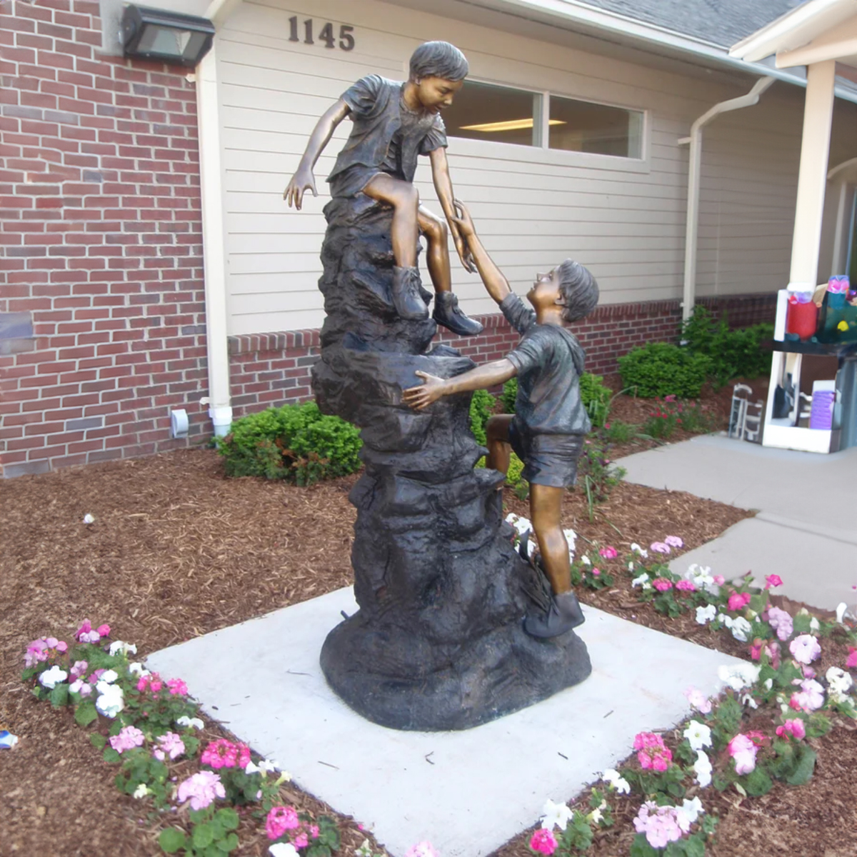 Boys Climbing Mountain Statue